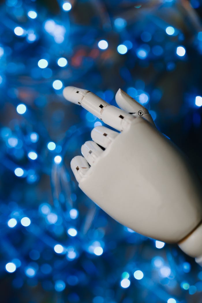 Mastering the First Impression: Your intriguing post title goes here Close-up of a robotic hand with glowing blue bokeh background, symbolizing advanced technology.